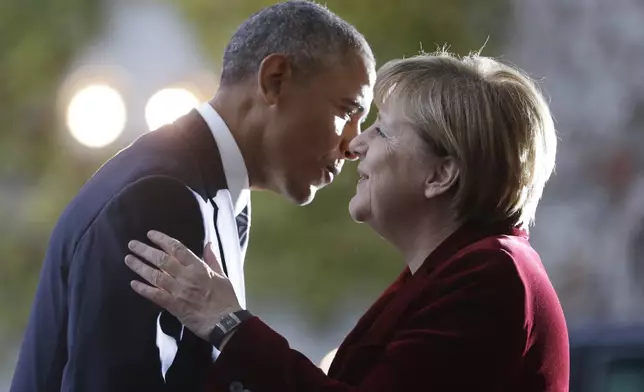 FILE - U.S. President Barack Obama, left, is welcomed by German Chancellor Angela Merkel prior to a meeting in the chancellery in Berlin, Germany, Thursday, Nov. 17, 2016. (AP Photo/Michael Sohn, File)