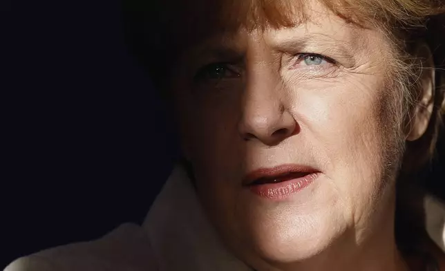 File - German Chancellor Angela Merkel is pictured with light and shadow at the Meseberg palace near Berlin, Germany, Thursday, Jan. 23, 2014. (AP Photo/Michael Sohn, File)