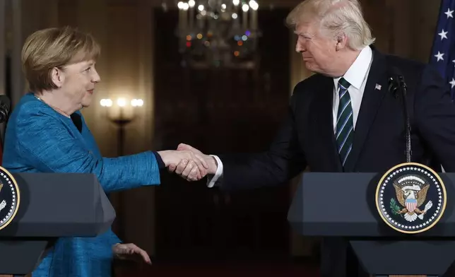 FILE - President Donald Trump and German Chancellor Angela Merkel shake hands following their joint news conference in the East Room of the White House in Washington, Friday, March 17, 2017. (AP Photo/Pablo Martinez Monsivais, File)