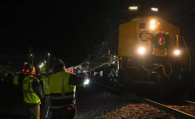 The CSX Holiday Express arrives, in Erwin, Tenn. Thursday, Nov. 21, 2024. The railway company held a celebration and concert for the town affected by Hurricane Helene. (AP Photo/George Walker IV)