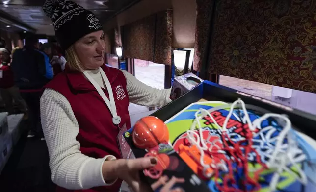 Diana Sorfleet prepares a gift bag during the 82nd run of the CSX Santa Train, Saturday, Nov. 23, 2024, in Dante, Va. (AP Photo/George Walker IV)