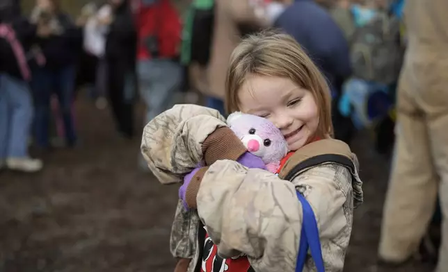 Brooklyn McCoy reacts to a gift she received during the 82nd run of the CSX Santa Train, Saturday, Nov. 23, 2024, in Dungannon, Va. (AP Photo/George Walker IV)