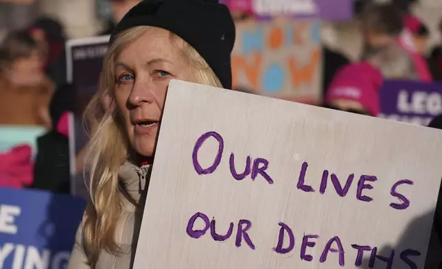 Pro legal assisted dying supporters demonstrate in front of Parliament in London, Friday, Nov. 29, 2024 as British lawmakers started a historic debate on a proposed to help terminally ill adults end their lives in England and Wales.(AP Photo/Alberto Pezzali)