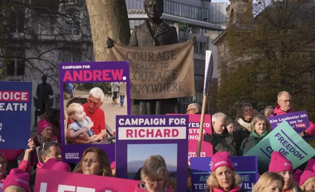 Pro legal assisted dying supporters demonstrate in front of Parliament in London, Friday, Nov. 29, 2024 as British lawmakers started a historic debate on a proposed to help terminally ill adults end their lives in England and Wales.(AP Photo/Alberto Pezzali)