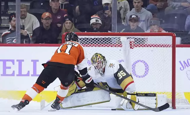 Philadelphia Flyers' Travis Konecny, left, cannot score against Vegas Golden Knights' Ilya Samsonov during a shootout in an NHL hockey game, Monday, Nov. 25, 2024, in Philadelphia. (AP Photo/Matt Slocum)