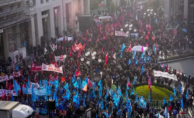 Demonstrators gather during a public and private sectors' national strike called by the labor unions to protest against the government's budget law ,in Milan, Italy, Friday, Nov. 29, 2024. (AP Photo/Luca Bruno)