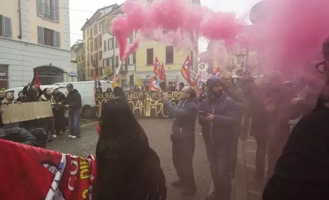 Demonstrators gather during a public and private sectors' national strike called by the labor unions to protest against the government's budget law ,in Milan, Italy, Friday, Nov. 29, 2024. (AP Photo/Luca Bruno)