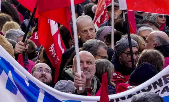 Demonstrators gather during a public and private sectors' national strike called by the labor unions to protest against the government's budget law ,in Milan, Italy, Friday, Nov. 29, 2024. (AP Photo/Luca Bruno)