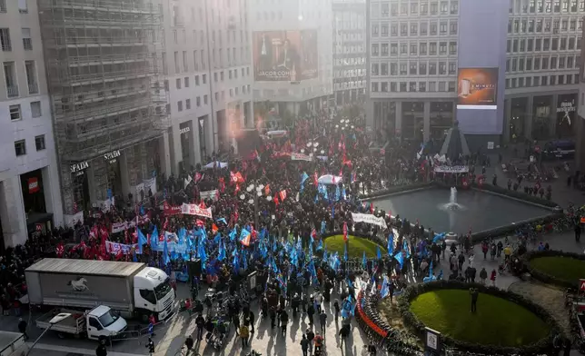 Demonstrators gather during a public and private sectors' national strike called by the labor unions to protest against the government's budget law ,in Milan, Italy, Friday, Nov. 29, 2024. (AP Photo/Luca Bruno)