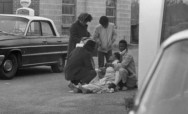 FILE - Amelia Boynton is aided by people after she was injured when state police broke up a demonstration march Boynton helped lead on the Edmund Pettus Bridge, in Selma, Ala., March 7, 1965. (AP Photo)