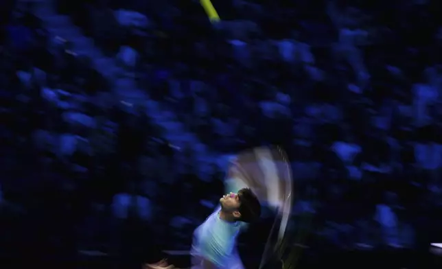 Spain's Carlos Alcaraz serves the ball to Russia's Andrey Rublev during their singles tennis match of the ATP World Tour Finals at the Inalpi Arena, in Turin, Italy, Wednesday, Nov. 13, 2024. (AP Photo/Antonio Calanni)