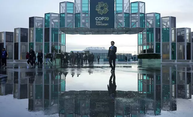 Attendees arrive for the day at the COP29 U.N. Climate Summit, Thursday, Nov. 14, 2024, in Baku, Azerbaijan. (AP Photo/Rafiq Maqbool)