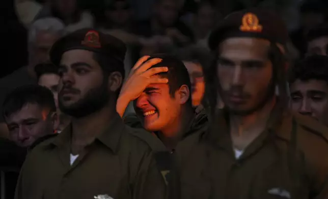 Mourners react during eulogies for Israeli soldier Capt. Itay Marcovich, who was killed in action in Lebanon, during his funeral in Kokhav Yair, Israel, Thursday, Nov. 14, 2024. (AP Photo/Ohad Zwigenberg)