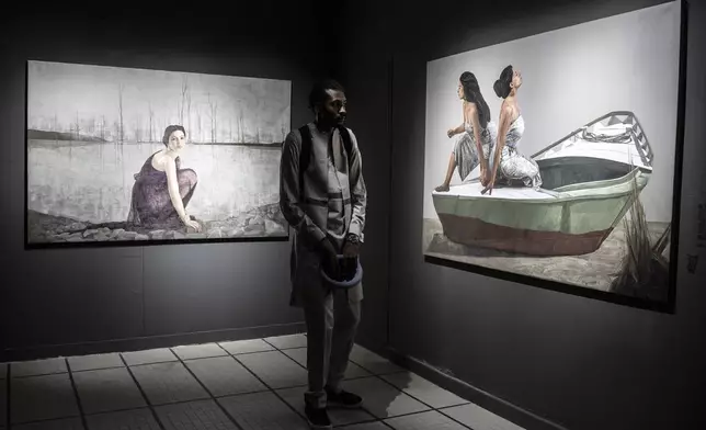 A visitor explores the international exhibit at the Dakar Biennale of Contemporary African Art in Dakar, Senegal, Friday, Nov. 8, 2024. (AP Photo/Annika Hammerschlag)