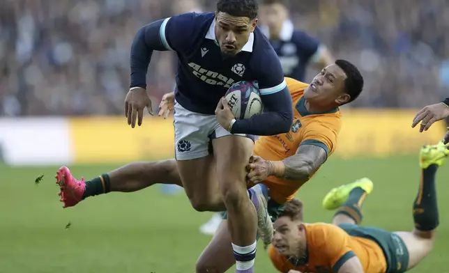 Scotland's Sione Tuipulotu runs to score a try during the Autumn Nations series rugby union match between Scotland and Australia in Edinburgh, Sunday, Nov. 24, 2024.(AP Photo/Scott Heppell)