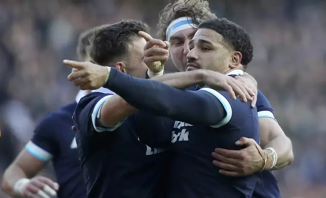 Scotland's Sione Tuipulotu , right, celebrates scoring a try during the Autumn Nations series rugby union match between Scotland and Australia in Edinburgh, Sunday, Nov. 24, 2024.(AP Photo/Scott Heppell)