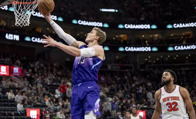 Utah Jazz forward Lauri Markkanen goes to the hoop ahead of New York Knicks center Karl-Anthony Towns (32) during the second half of an NBA basketball game, Saturday, Nov. 23, 2024, in Salt Lake City. (AP Photo/Spenser Heaps)