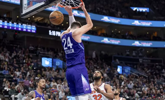 Utah Jazz center Walker Kessler (24) dunks over New York Knicks center Karl-Anthony Towns (32) during the second half of an NBA basketball game, Saturday, Nov. 23, 2024, in Salt Lake City. (AP Photo/Spenser Heaps)