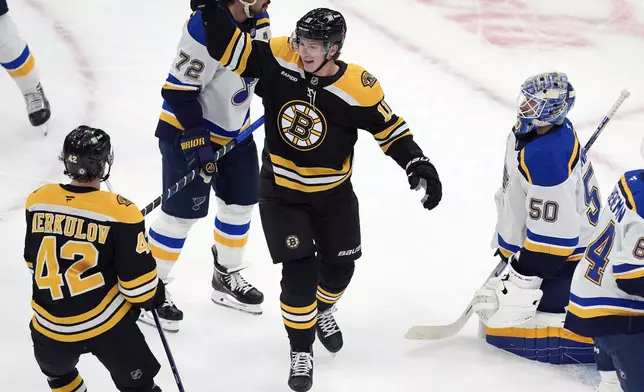 Boston Bruins' Trent Frederic (11) celebrates his second goal of the first period past St. Louis Blues' Jordan Binnington (50) during an NHL hockey game, Saturday, Nov. 16, 2024, in Boston. (AP Photo/Michael Dwyer)