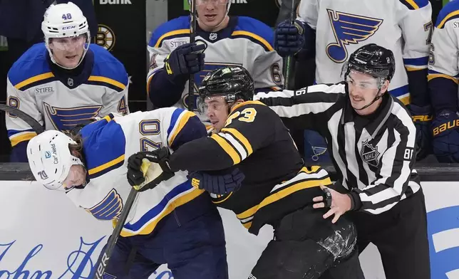 Boston Bruins' Charlie McAvoy (73) commits a rouging penalty on St. Louis Blues' Oskar Sundqvist (70) during the second period of an NHL hockey game, Saturday, Nov. 16, 2024, in Boston. (AP Photo/Michael Dwyer)