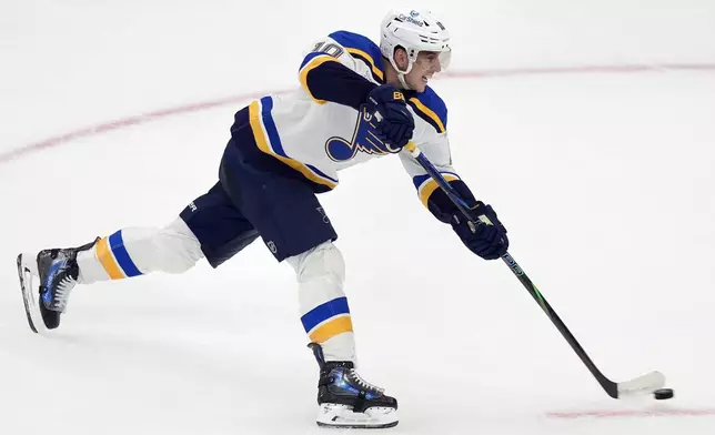 St. Louis Blues' Brayden Schenn scores the game-winning goal during overtime in an NHL hockey game against the Boston Bruins, Saturday, Nov. 16, 2024, in Boston. (AP Photo/Michael Dwyer)