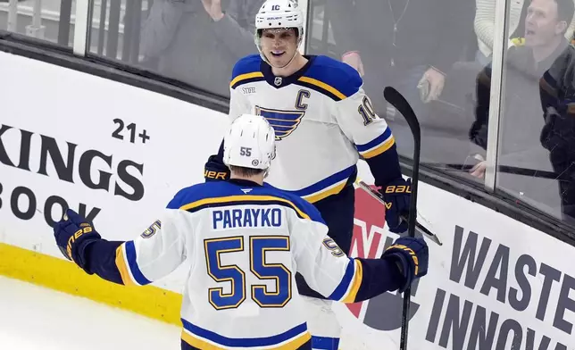 St. Louis Blues' Brayden Schenn (10) celebrates with Colton Parayko (55) after scoring in overtime during an NHL hockey game against the Boston Bruins, Saturday, Nov. 16, 2024, in Boston. (AP Photo/Michael Dwyer)