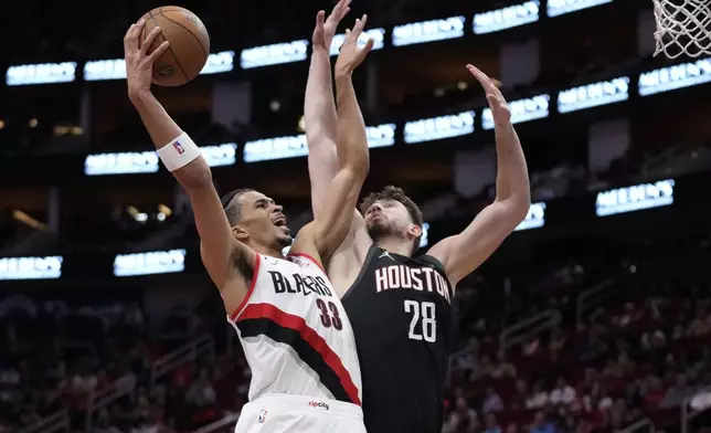 Portland Trail Blazers forward Toumani Camara (33) shoots against Houston Rockets center Alperen Sengun (28) during the first half of an Emirates NBA Cup basketball game in Houston, Friday, Nov. 22, 2024. (AP Photo/Ashley Landis)