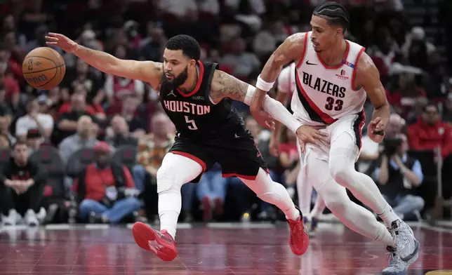 Houston Rockets guard Fred VanVleet (5) runs after a loose ball while defended by Portland Trail Blazers forward Toumani Camara (33) during the first half of an Emirates NBA Cup basketball game in Houston, Friday, Nov. 22, 2024. (AP Photo/Ashley Landis)