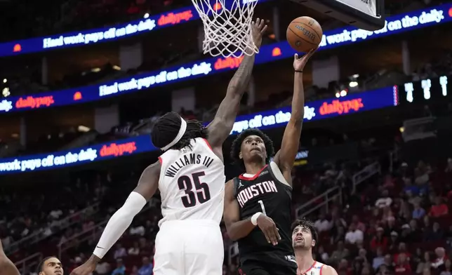 Houston Rockets forward Amen Thompson (1) shoots against Portland Trail Blazers center Robert Williams III (35) during the second half of an Emirates NBA Cup basketball game in Houston, Friday, Nov. 22, 2024. (AP Photo/Ashley Landis)