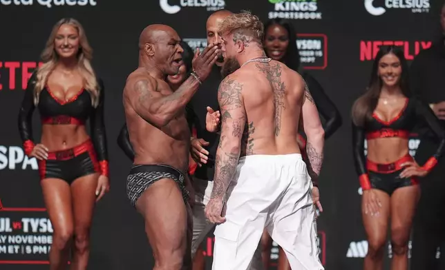 Mike Tyson, left, slaps Jake Paul during a weigh-in ahead of their heavyweight bout, Thursday, Nov. 14, 2024, in Irving, Texas. (AP Photo/Julio Cortez)