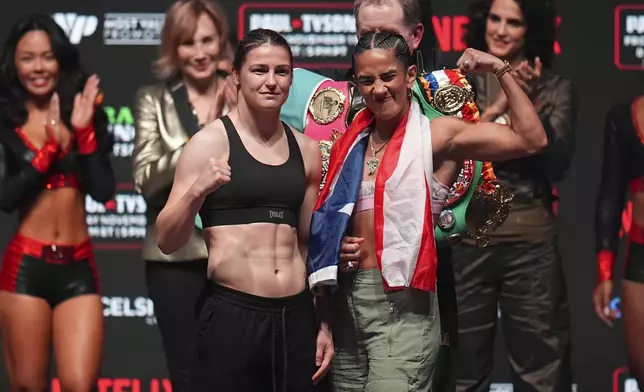 Katie Taylor, left, and Amanda Serranon pose during a weigh-in ahead of their undisputed super lightweight title bout, Thursday, Nov. 14, 2024, in Irving, Texas. (AP Photo/Julio Cortez)