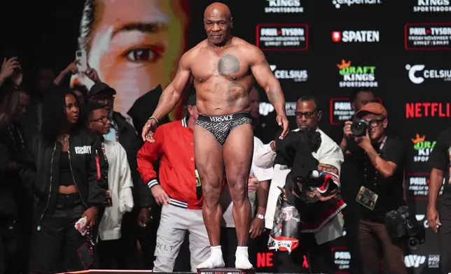 Mike Tyson steps on the scale during a weigh-in ahead of his heavyweight bout against Jake Paul, Thursday, Nov. 14, 2024, in Irving, Texas. (AP Photo/Julio Cortez)