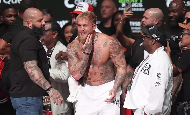 Jake Paul reacts after being slapped by Mike Tyson during a weigh-in ahead of their heavyweight bout, Thursday, Nov. 14, 2024, in Irving, Texas. (AP Photo/Julio Cortez)