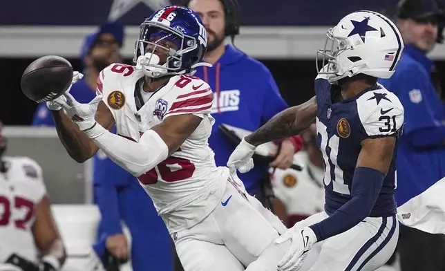 New York Giants wide receiver Darius Slayton (86) is unable to catch a pass in front of Dallas Cowboys cornerback Josh Butler (31) during the first half of an NFL football game in Arlington, Texas, Thursday, Nov. 28, 2024. (AP Photo/Tony Gutierrez)