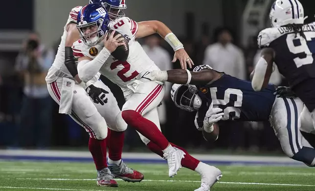 New York Giants quarterback Drew Lock (2) is sacked by Dallas Cowboys defensive end Carl Lawson (55) during the first half of an NFL football game in Arlington, Texas, Thursday, Nov. 28, 2024. (AP Photo/Tony Gutierrez)