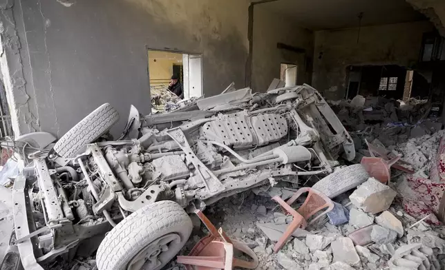 A man inspects a house damaged in Israeli airstrikes, in Baalbek, eastern Lebanon, Thursday, Nov. 28, 2024. (AP Photo/Hassan Ammar)