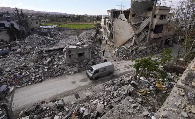 Residents inspect a destroyed neighbourhood in Baalbek, eastern Lebanon, Thursday, Nov. 28, 2024. (AP Photo/Hassan Ammar)