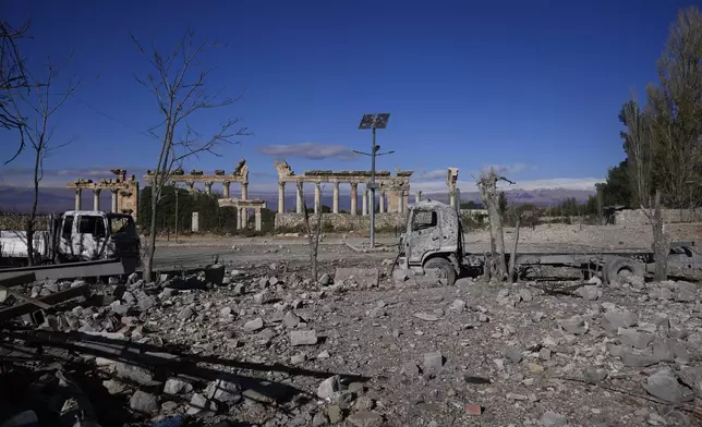 Damaged vehicles seen in front of the Roman temples of Baalbek in eastern Lebanon, Thursday, Nov. 28, 2024. (AP Photo/Hassan Ammar)