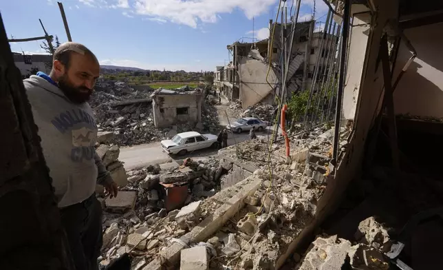 A resident checks a destroyed apartment in Baalbek, eastern Lebanon, Thursday, Nov. 28, 2024. (AP Photo/Hassan Ammar)