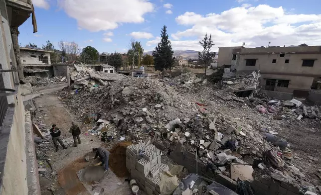 Residents rebuild their houses damaged in Israeli airstrikes, in Baalbek, eastern Lebanon, Thursday, Nov. 28, 2024. (AP Photo/Hassan Ammar)