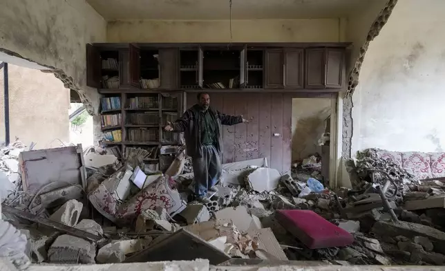 A man inspects a house that was destroyed in Israeli airstrikes in Baalbek, eastern Lebanon, Thursday, Nov. 28, 2024. (AP Photo/Hassan Ammar)