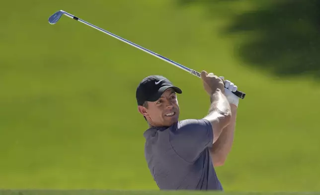 Rory McIlroy of Northern Ireland hits a shot from a bunker on the 4th hole during the second round of World Tour Golf Championship in Dubai, United Arab Emirates, Friday, Nov. 15, 2024. (AP Photo/Altaf Qadri)