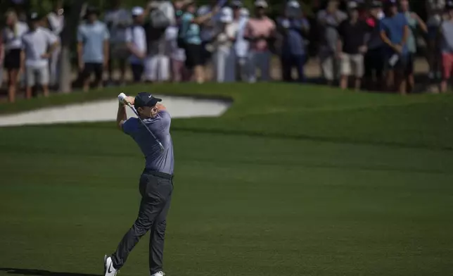 Rory McIlroy of Northern Ireland plays his second shot on the 3rd hole during the second round of World Tour Golf Championship in Dubai, United Arab Emirates, Friday, Nov. 15, 2024. (AP Photo/Altaf Qadri)