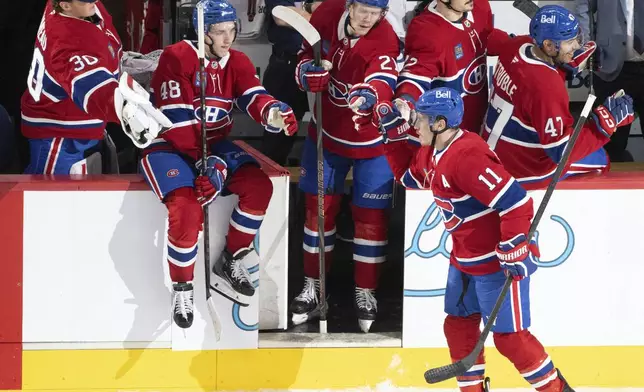 Montreal Canadiens' Brendan Gallagher (11) celebrates after his goal against the Edmonton Oilers with teammates during second-period NHL hockey game action in Montreal, Monday, Nov. 18, 2024. (Christinne Muschi/The Canadian Press via AP)