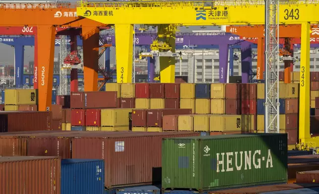 FILE - Shipping containers are stacked at a port in Tianjin, China, Jan. 16, 2023. (AP Photo/Mark Schiefelbein, File)