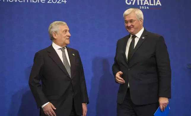 Italian Foreign Minister Antonio Tajani, left, welcomes Ukrainian Foreign Minister Andrii Sybiha for a family photo at the G7 of foreign Ministers in Fiuggi, some 70 kilometers south-east of Rome, Tuesday, Nov. 26, 2024. (AP Photo/Alessandra Tarantino, Pool)