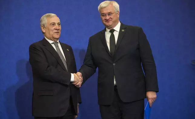 Italian Foreign Minister Antonio Tajani, left, welcomes Ukrainian Foreign Minister Andrii Sybiha for a family photo at the G7 of foreign Ministers in Fiuggi, some 70 kilometers south-east of Rome, Tuesday, Nov. 26, 2024. (AP Photo/Alessandra Tarantino, Pool)