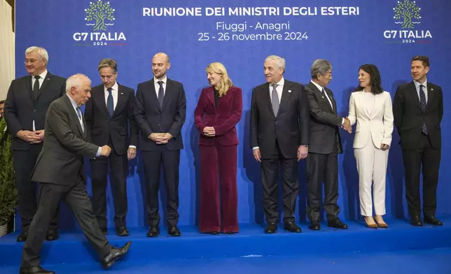 European Union foreign policy chief Josep Borrell, front, arrives to pose for a family photo with, from left, Ukrainian Foreign Minister Andrii Sybiha, U.S. Secretary of State Antony Blinken, French Foreign Minister Jean-Noël Barrot, Canada's Foreign Minister Melanie Joly, Italian Foreign Minister Antonio Tajani, Japanese Foreign Minister Takeshi Iwaya, German Foreign Minister Annalena Baerbock, Britain's Foreign Office Political Director Christian Turner at the G7 of foreign Ministers in Fiuggi, some 70 kilometers south-east of Rome, Tuesday, Nov. 26, 2024. (AP Photo/Alessandra Tarantino, Pool)