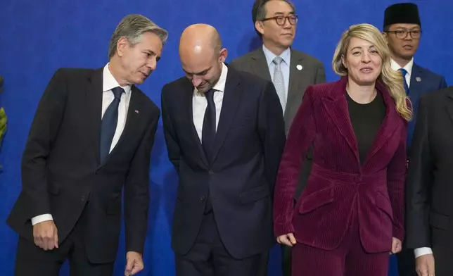 From left front row, U.S. Secretary of State Antony Blinken, foreign MInisters of France, Jean-Noël Barrot, Canada, Melanie Joly, wait for a family photo with, second row from left, foreign Ministers of South Korea, Tae-yul Cho, and Indonesia, Sugiono at the G7 of foreign Ministers in Fiuggi, some 70 kilometers south-east of Rome, Tuesday, Nov. 26, 2024. (AP Photo/Alessandra Tarantino, Pool)