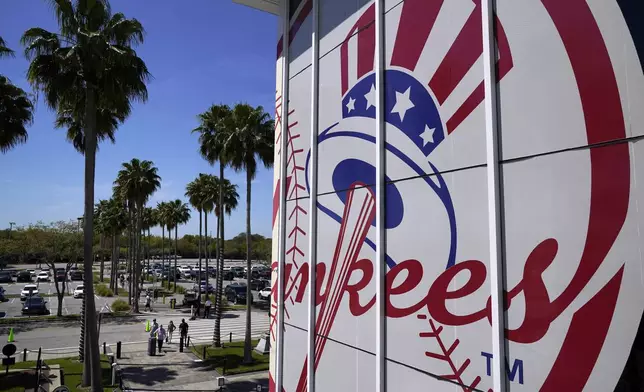 FILE - Fans arrive at George M. Steinbrenner Field for a spring training exhibition baseball game between the New York Yankees and the Pittsburgh Pirates in Tampa, Fla., Saturday, March 13, 2021. (AP Photo/Gene J. Puskar